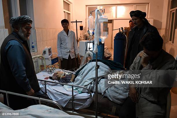 An Afghan wounded girl receive treatment at the Ali Abad hospital after an attack by gunmen inside the Kart-e- Sakhi shrine in Kabul on October 11,...