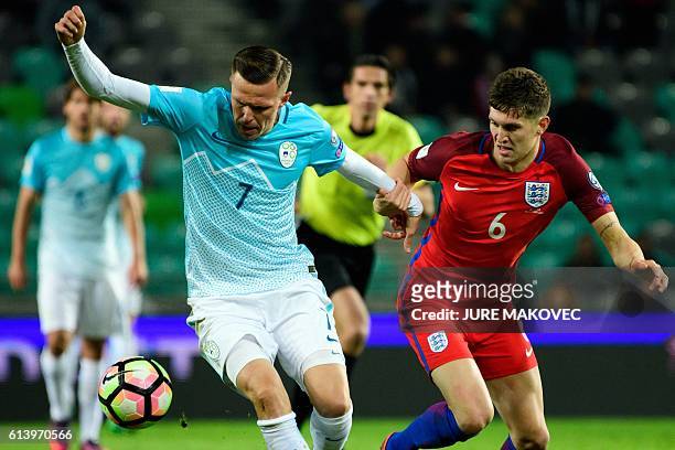 Slovenia's midfielder Josip Ilicic vies for the ball with England's defender John Stones during the Fifa World Cup 2018 football qualification match...