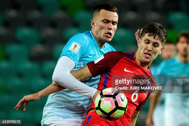 Slovenia's midfielder Josip Ilicic vies for the ball with England's defender John Stones during the Fifa World Cup 2018 football qualification match...