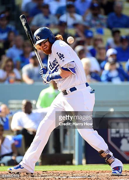 Justin Turner of the Los Angeles Dodgers is hit by a pitch in the first inning against the Washington Nationals during game four of the National...