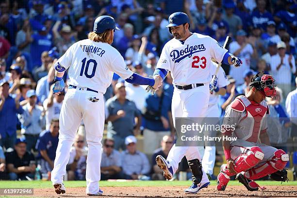 Adrian Gonzalez celebrates his two-run homerun with Justin Turner of the Los Angeles Dodgers in the first inning against the Washington Nationals...