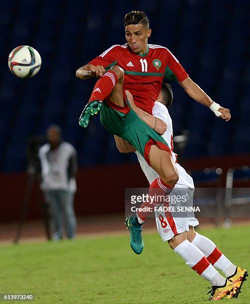 Morocco's Fajr faycal vies for the ball against Canada's Bustos Marco during the Morocco vs Canada friendly match at the Marrakech Grand Stadium in...