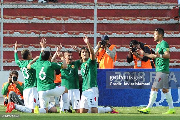 Pablo Escobar of Bolivia celebrates with teammates after scoring the second goal of his team during a match between Bolivia and Ecuador as part of...