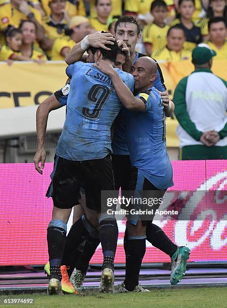 Luis Suarez of Uruguay celebrates with teammates after scoring the second goal of his team during a match between Colombia and Uruguay as part of...