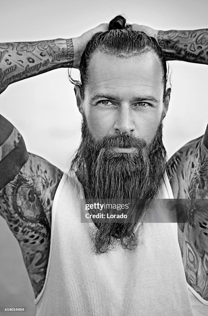 Handsome Bearded Tattooed Man Posing For Portrait High-Res Stock Photo -  Getty Images