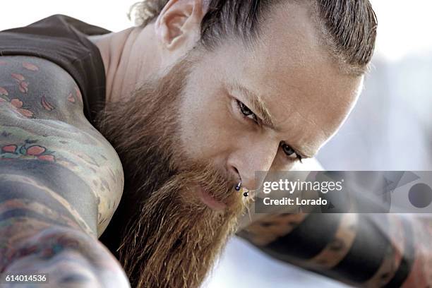 primer plano de barbudo tatuado de ojos azules guapo hombre - vikingo fotografías e imágenes de stock