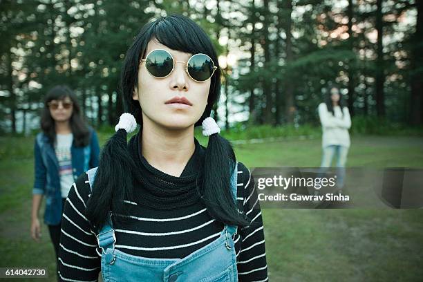 cool late teen asian girl wearing sunglasses looking at camera. - sunglasses reflection stock pictures, royalty-free photos & images