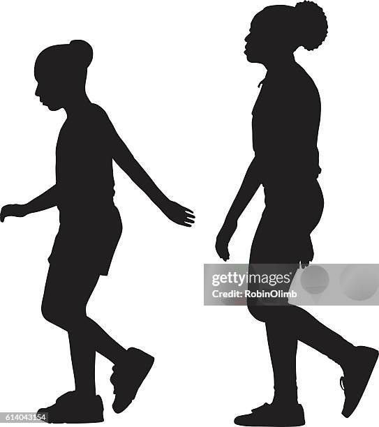 two girls walking together sihouette - black silhouette stock illustrations