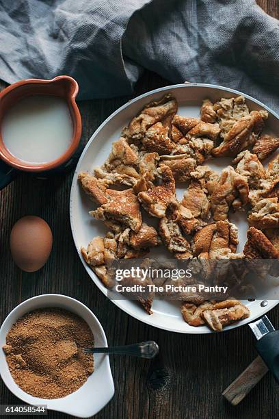 kaiserschmarrn or shredded pancake in a pan on a rustic wooden table - kaiserschmarrn stock pictures, royalty-free photos & images