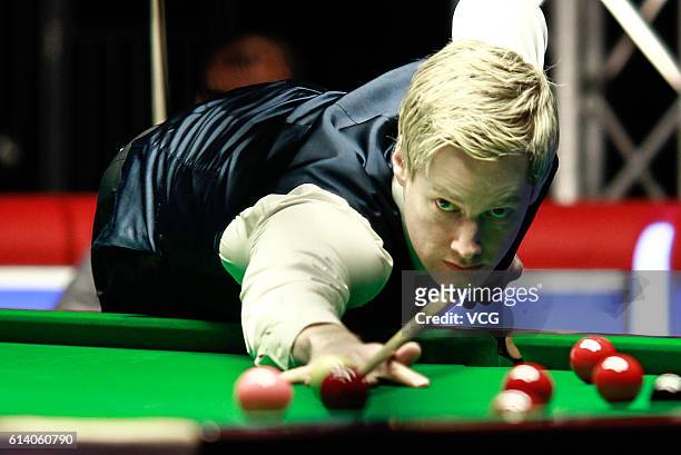 Neil Robertson of Australia plays a shot against Hamza Akbar of Pakistan during the first round match on day two of the Coral English Open 2016 at...