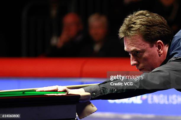 Ken Doherty of Ireland plays a shot against Judd Trump of England during the first round match on day two of the Coral English Open 2016 at Event...