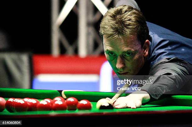 Ken Doherty of Ireland plays a shot against Judd Trump of England during the first round match on day two of the Coral English Open 2016 at Event...