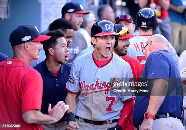 Trea Turner of the Washington Nationals reacts after scoring on a two RBI single hit by Daniel Murphy in the seventh inning against the Los Angeles...