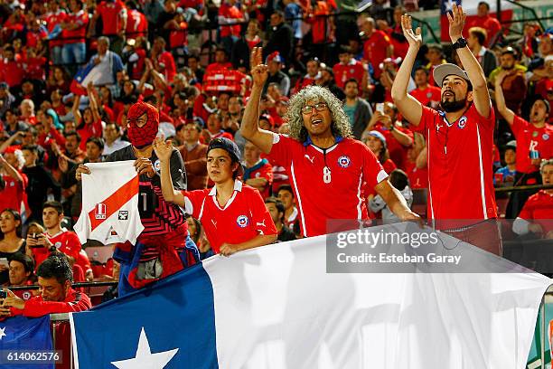 Fans of Chile cheer for their team before a match between Chile and Peru as part of FIFA 2018 World Cup Qualifiers at at Nacional Stadium on October...