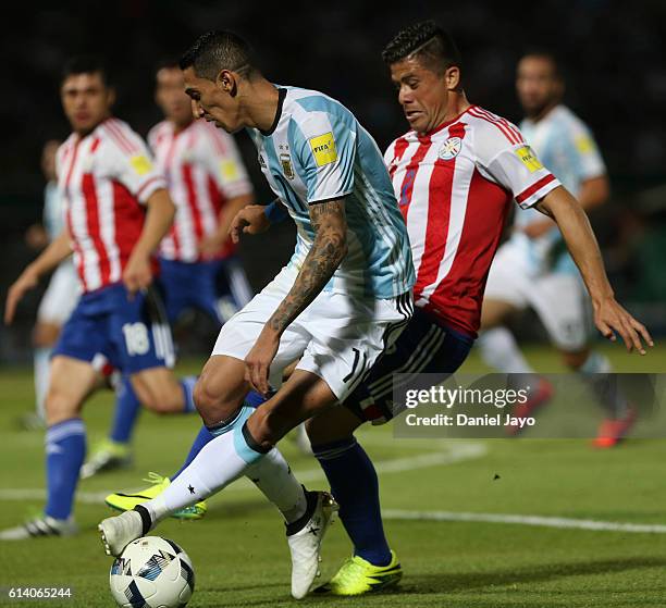 Angel Di Maria, of Argentina, and Jorge Moreira, of Paraguay, fight for the ball during a match between Argentina and Paraguay as part of FIFA 2018...
