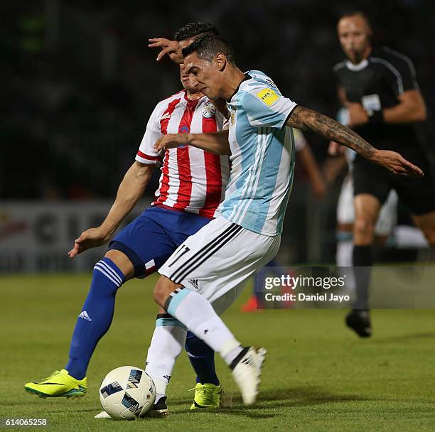 Angel Di Maria, of Argentina, and Jorge Moreira, of Paraguay, fight for the ball during a match between Argentina and Paraguay as part of FIFA 2018...