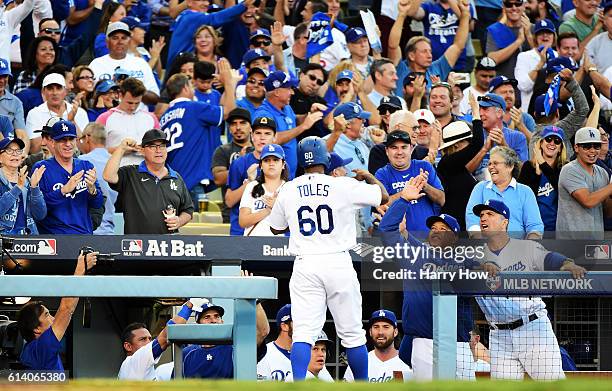 Manager Dave Roberts celebrates with Andrew Toles of the Los Angeles Dodgers in the eighth inning after Toles scored on a single by Chase Utley...