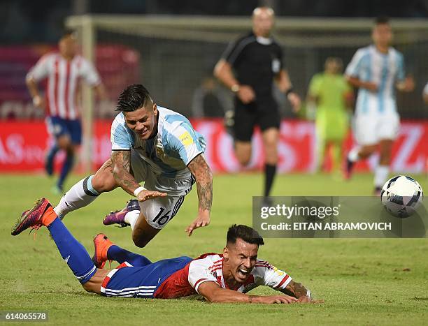 Argentina's Marcos Rojo vies for the ball with Paraguay's midfielder Hernan Perez during their Russia 2018 World Cup football qualifier match in...