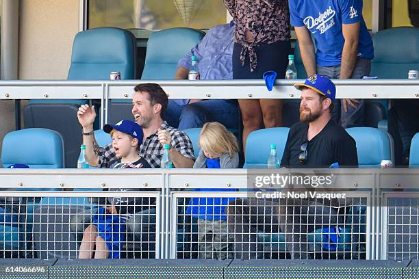 Rob McElhenney, Axel Lee McElhenney and Leo Grey McElhenney attend a baseball game between the Washington Nationals and Los Angeles Dodgers at Dodger...