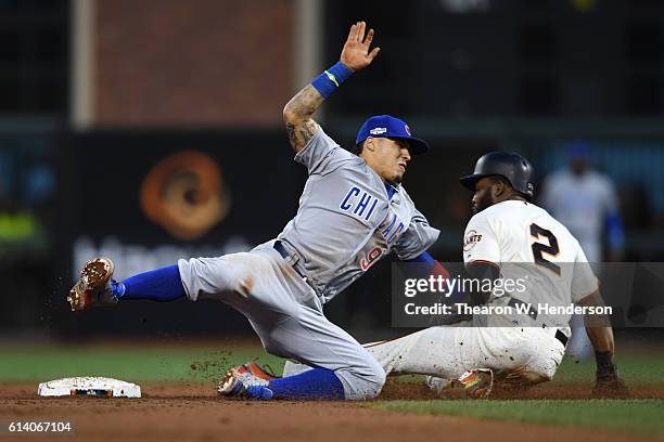 Javier Baez of the Chicago Cubs tags out Denard Span of the San Francisco Giants attempting to steal second base in the third inning of Game Four of...