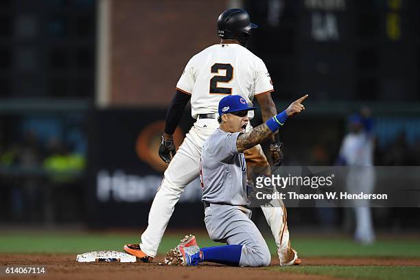 Javier Baez of the Chicago Cubs reacts after tagging out Denard Span of the San Francisco Giants attempting to steal second base in the third inning...
