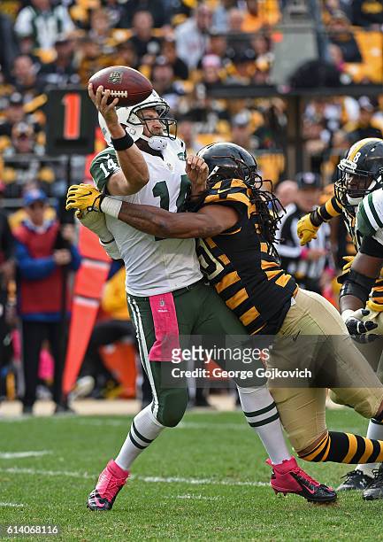 Quarterback Ryan Fitzpatrick of the New York Jets passes as he is hit by linebacker Jarvis Jones of the Pittsburgh Steelers during a game at Heinz...