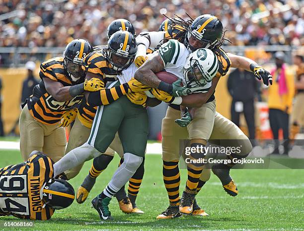 Running back Matt Forte of the New York Jets is tackled by linebackers Lawrence Timmons, Vince Williams Anthony Chickillo and Jarvis Jones and...