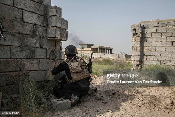 The 5th of JUNE 2016."nThe first houses of Fallujah are reached by the Golden Division. Units are sent to search it."nA soldier take position, facing...