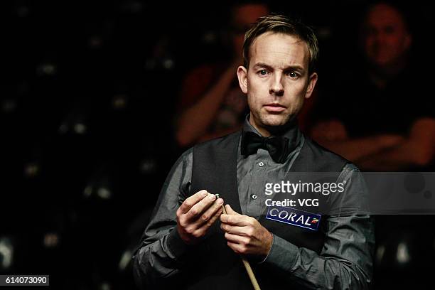 Ali Carter of England chalks the cue during the first round match against Luca Brecel of Belgium on day two of the Coral English Open 2016 at Event...
