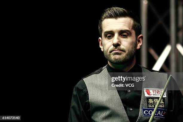 Mark Selby of England reacts during the first round match against Gary Wilson of England on day two of the Coral English Open 2016 at Event City on...