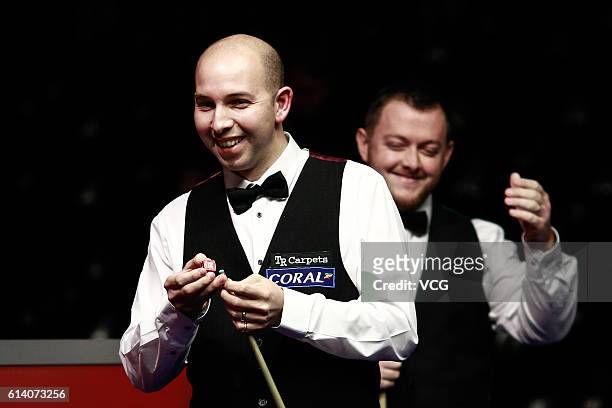 Jamie Curtis-Barrett of England chalks the cue during the first round match against Mark Allen of Northern Ireland on day two of the Coral English...