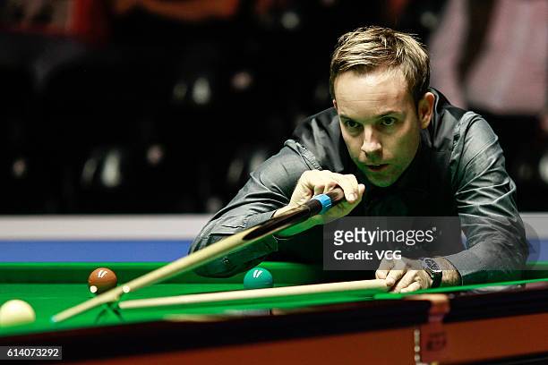 Ali Carter of England plays a shot during the first round match against Luca Brecel of Belgium on day two of the Coral English Open 2016 at Event...