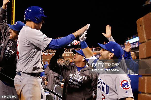 Anthony Rizzo of the Chicago Cubs celebrates after scoring in the ninth inning of Game Four of their National League Division Series against the San...