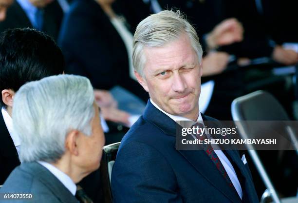 Belgium's King Philippe winks at the media as he sits with Japan's Emperor Akihito at the Yuki Information Communication Center in Yuki, Ibaraki...