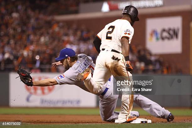 John Lackey of the Chicago Cubs is unable to make the play against Denard Span of the San Francisco Giants at first base in the fourth inning of Game...