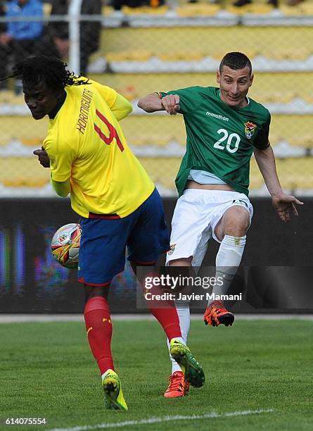 Juan Carlos Paredes of Ecuador and Pablo Escobar of Bolivia fight for the ball during a match between Bolivia and Ecuador as part of FIFA 2018 World...