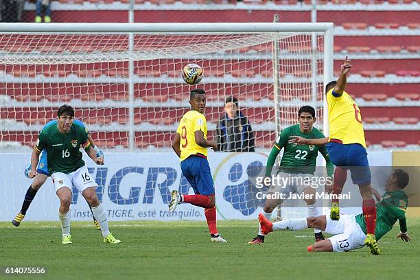 Christian Noboa of Ecuador kicks the ball as Ronald Raldes and Edward Zenteno of Bolivia defend during a match between Bolivia and Ecuador as part of...
