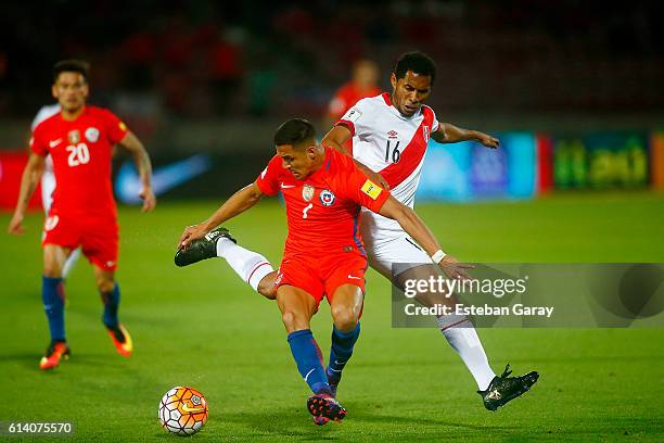 Alexis Sanchez of Chile fights for the ball with Carlos Lobaton of Peru during a match between Chile and Peru as part of FIFA 2018 World Cup...