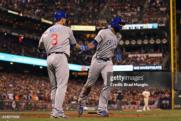 Jason Heyward of the Chicago Cubs is greeted by teammate David Ross after scoring the go-ahead run in the ninth inning during Game 4 of NLDS against...