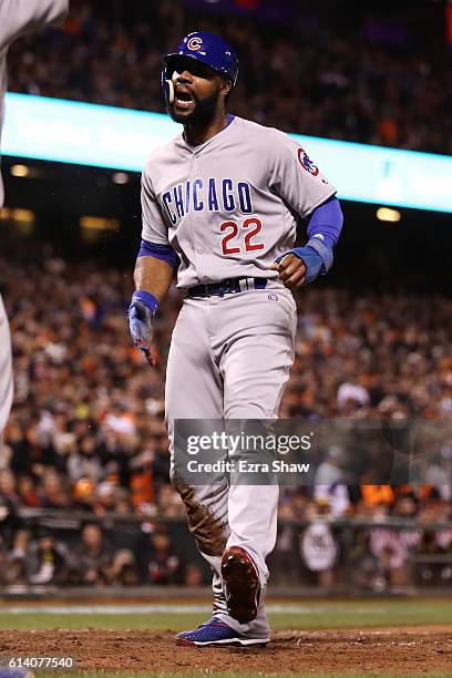 Jason Heyward of the Chicago Cubs scores the go ahead run on a RBI single by Javier Baez in the eighth inning of Game Four of their National League...