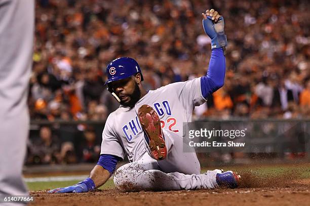 Jason Heyward of the Chicago Cubs scores the go ahead run on a RBI single by Javier Baez in the eighth inning of Game Four of their National League...