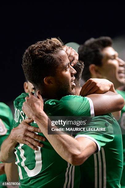 Oribe Peralta of Mexico celebrates his goal with his teamamte Giovani Dos Santos against Panama during the friendly football match between the...