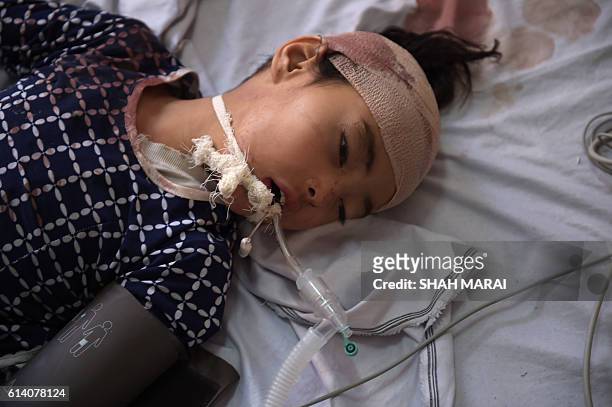 An Afghan wounded girl Frishta receives treatment at the Ali Abad hospital after an attack by gunmen inside the Karte Sakhi shrine in Kabul on...