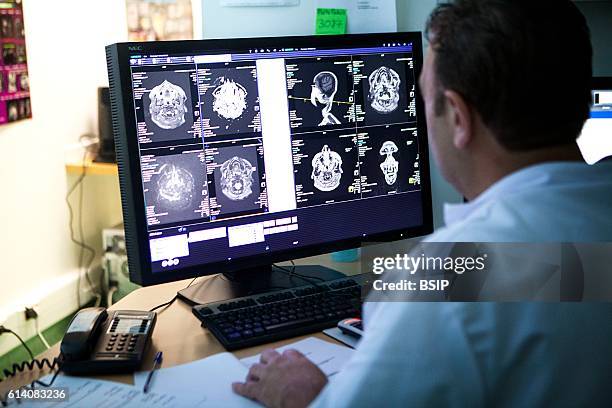 Radiology service in a hospital in Haute-Savoie, France. A doctor interprets a patients MRI scan.
