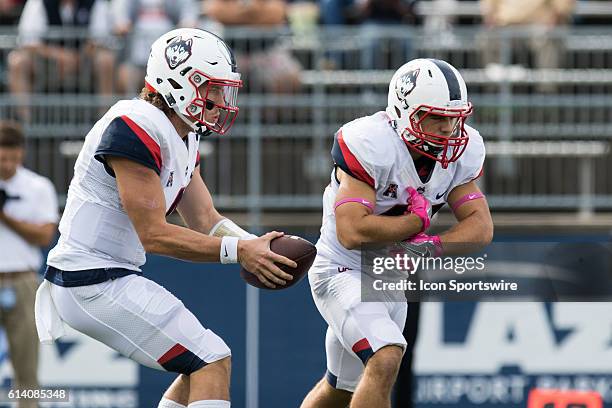 UConn Quarterback Bryant Shirreffs fakes a hand off to Michael Tarbutt during the first half of a NCAA football game between, AAC rivals, the...