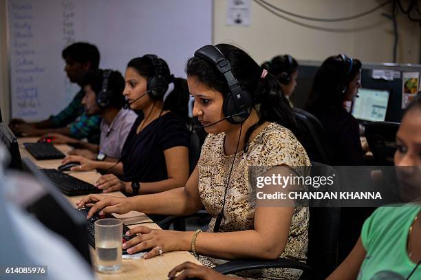 In this photograph taken on September 7 an Indian woman works at a call center of TravelKhana in Noida. Passengers on India's vast railway network...