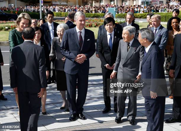 Belgium's King Philippe and Queen Mathilde and Japan's Emperor Akihito and Empress Michiko are greeted by officials upon their arrival at the Yuki...