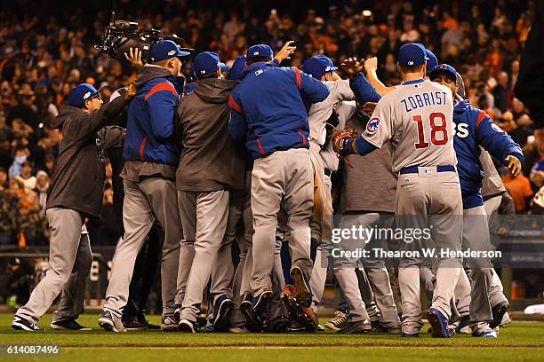 The Chicago Cubs celebrate after defeating the San Francisco Giants 6-5 in Game Four of their National League Division Series to advance to the...