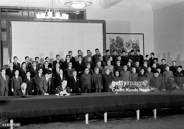 Beijing, China - File photo taken Sept. 29 shows Japanese Prime Minister Kakuei Tanaka and Chinese Premier Zhou Enlai signing a joint statement to...