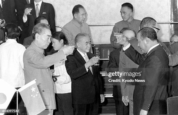 Japan - File photo taken Sept. 29 shows Japanese Prime Minister Kakuei Tanaka and Chinese Premier Zhou Enlai raising glasses in a toast after the two...